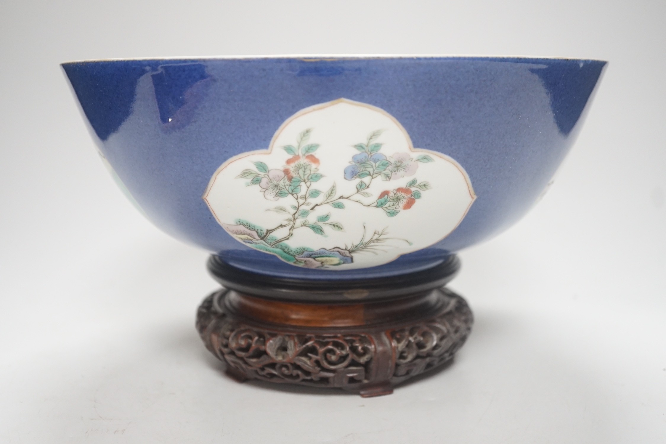 A 19th century Chinese famille verte powder blue bowl, 26cm diameter, wood stand